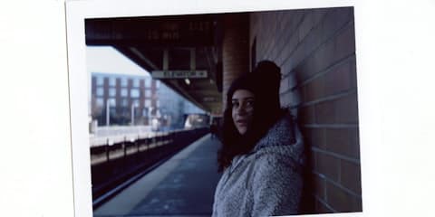 Instant film print with its white border showing a woman in a fur coat, an example of the 1980s Polaroid style